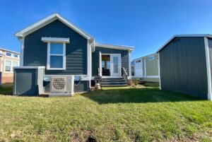 View of the outside of 2 bed tiny home with shed