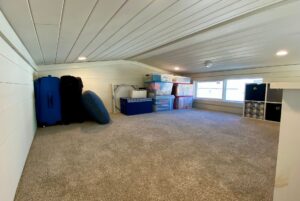 Loft in tiny home with carpet and windows