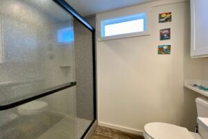 Walk-in shower in bathroom with large glass doors