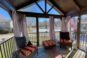 screened in covered porch with view on the pond