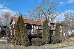 View of tiny home on corner lot with landscaping