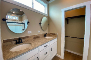 Bathroom view with double vanity and bathroom storage