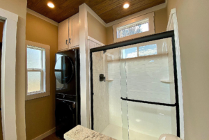 Walk-in shower with stackable washer dryer appliance