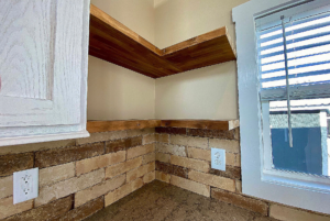 Lovely backsplash in kitchen with floating shelving