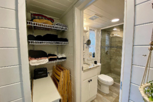 Bathroom view with lovely shower and storage space