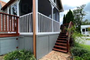 Wooden stairs lead to a screened-in porch with white railings at 40 Drifting Brook Lane real estate.