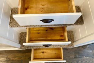 Three open drawers with white fronts and black handles, viewed from above in a 40 Drifting Brook Lane real estate listing.