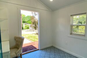 Small, bright room at 40 Drifting Brook, with chair, patterned floor, and yard views—perfect for real estate tours.