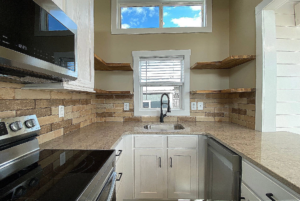 View of kitchen counter and floating shelves