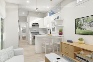 Bright, modern kitchen and living room with white cabinets, island seating, and a wall-mounted TV.