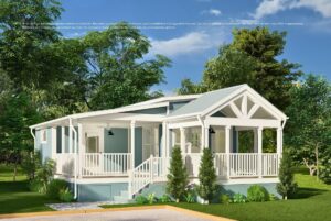 Light blue manufactured home with white trim, large porch, and green trees surrounding it on a sunny day.