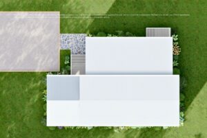 Aerial view of a modern white-roofed house with a stone path, surrounded by green lawn and plants.