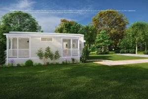A modern white tiny house with a porch sits on a lush green lawn surrounded by trees and landscaping.