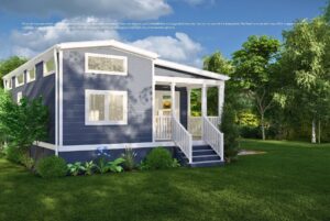 A modern tiny house with a porch, surrounded by green grass, trees, and garden plants on a sunny day.