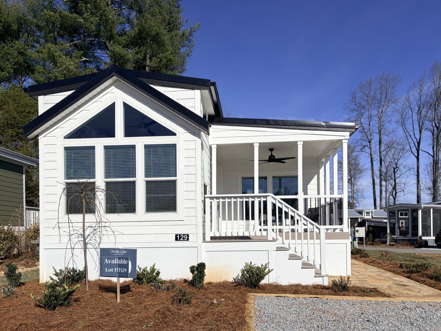 Tiny home with front porch and large windows.