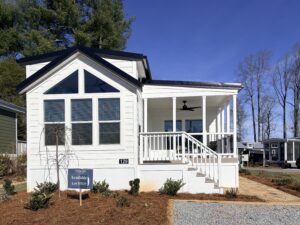 Tiny home with front porch and large windows.