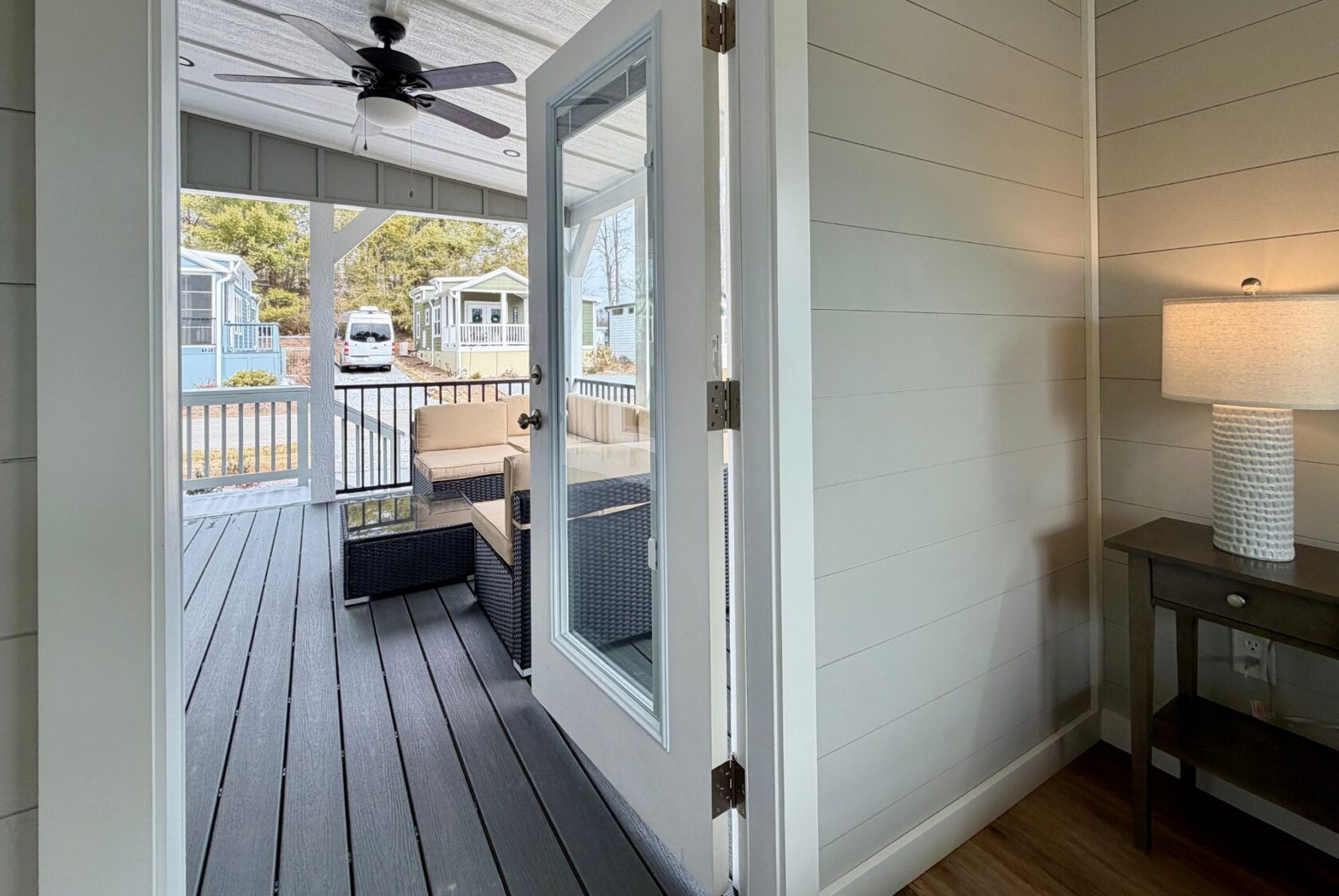 Open door leads from a cozy room to a covered porch at 124 Misty Knoll Way, with outdoor seating and scenic views.