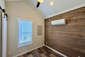 Small modern room with wood accent wall, window blinds, and a Strolling Easy Lane vibe.