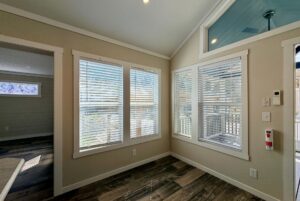 Small room with large windows, white blinds, and dark wood floor—perfect for strolling Easy Lane in natural light.