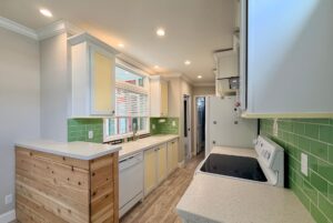 Modern kitchen with green tile backsplash and wood accents—it's like strolling Easy Lane at home.