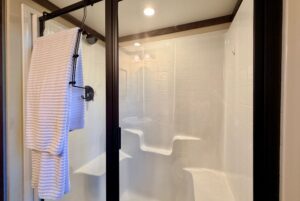 A glass shower with built-in seats at 54 Highland Hollow.