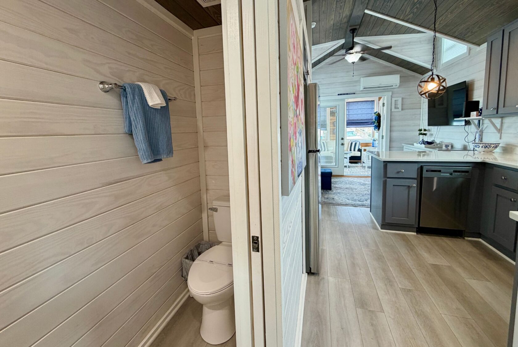 Modern bathroom with a towel, beside the kitchen and living area in a Mount Meadow Lane tiny house.