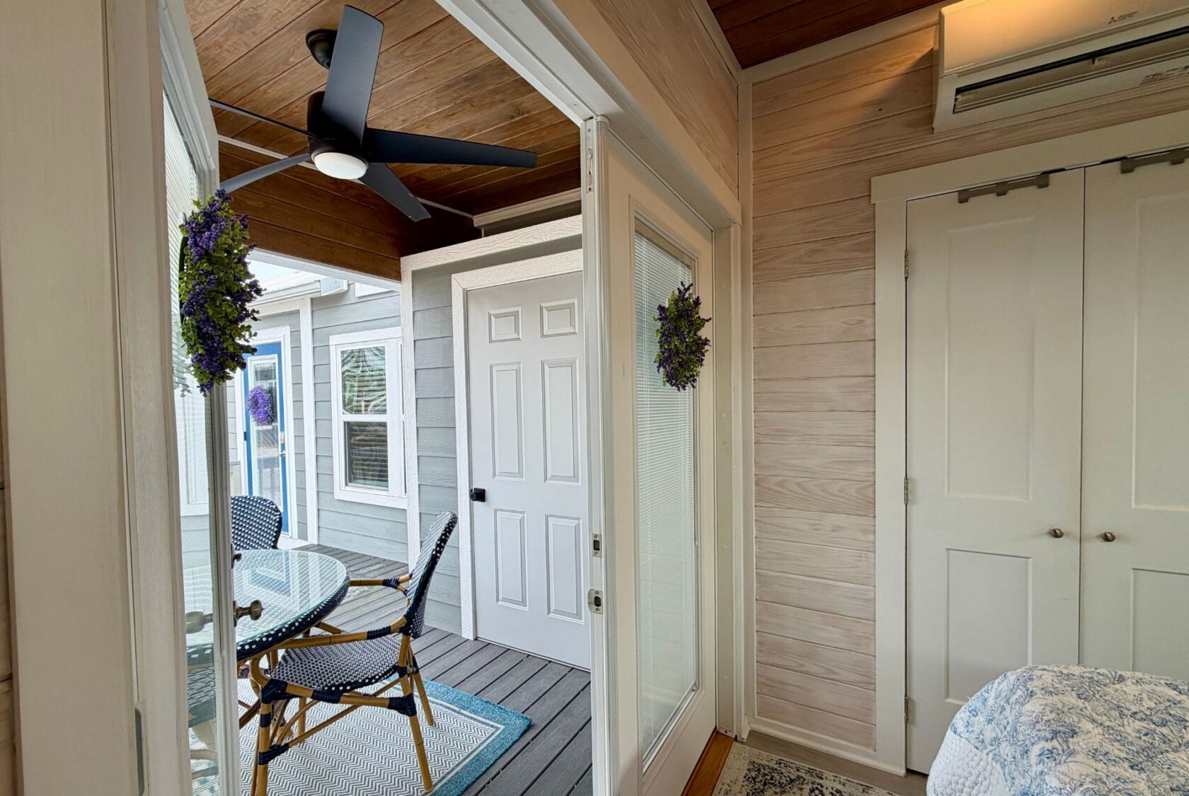 A cozy sunroom at 86 Mount Meadow Lane with a ceiling fan, table, chairs, and a patio door to the outdoors.