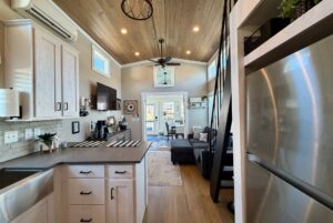 Modern Mount Meadow Lane tiny home with loft, kitchen, living area, and large windows for natural light.