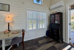 Small, bright room at 47 Drifting Brook Lane with a desk, chair, lamp, cabinet, and sunlit window—perfect for real estate tours.