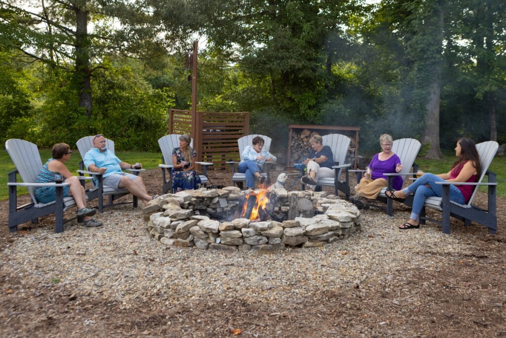 Residents gather around the firepit in the evening, enjoying the best place to retire in NC. 