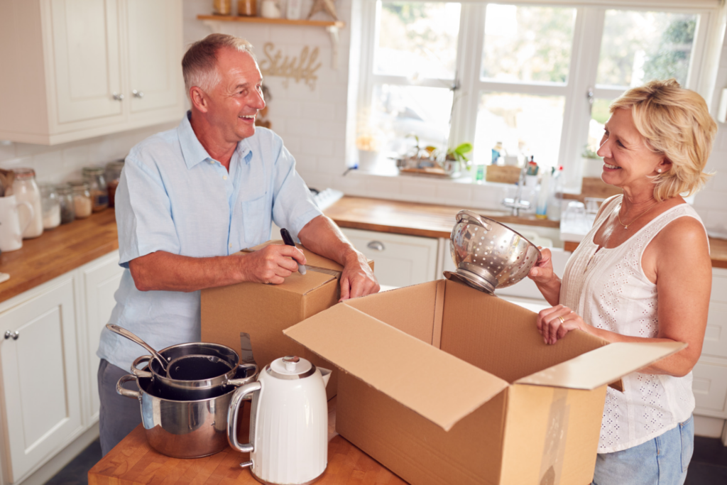 People Unpacking Boxes in a Kitchen - How to Downsize